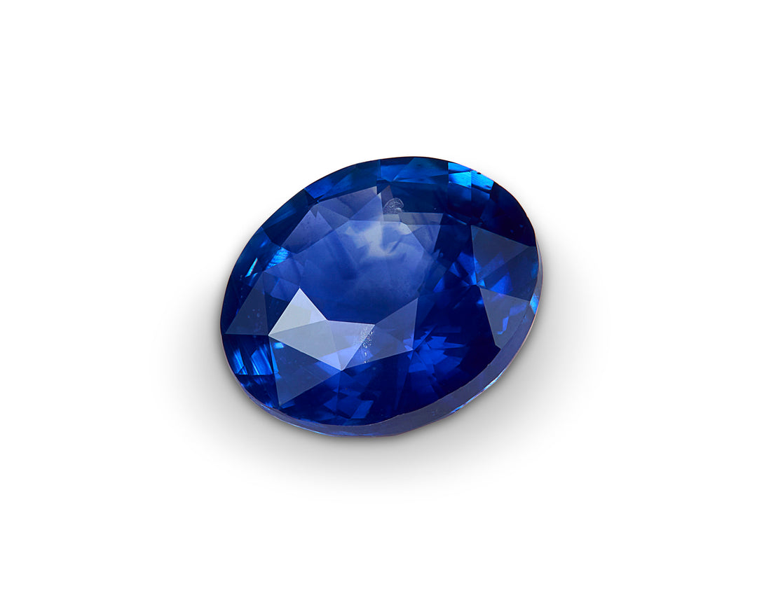 Faceted blue gemstone on a white background