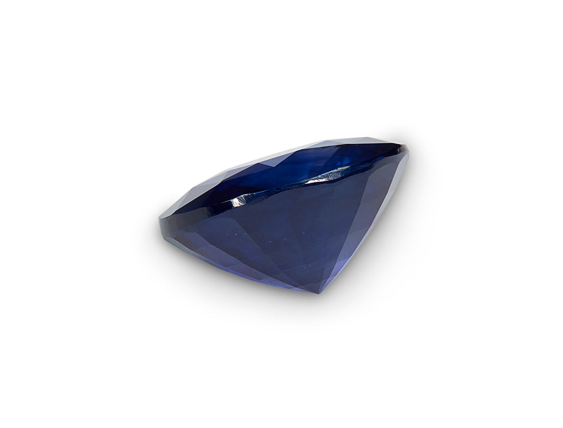 Faceted blue gemstone on a white background