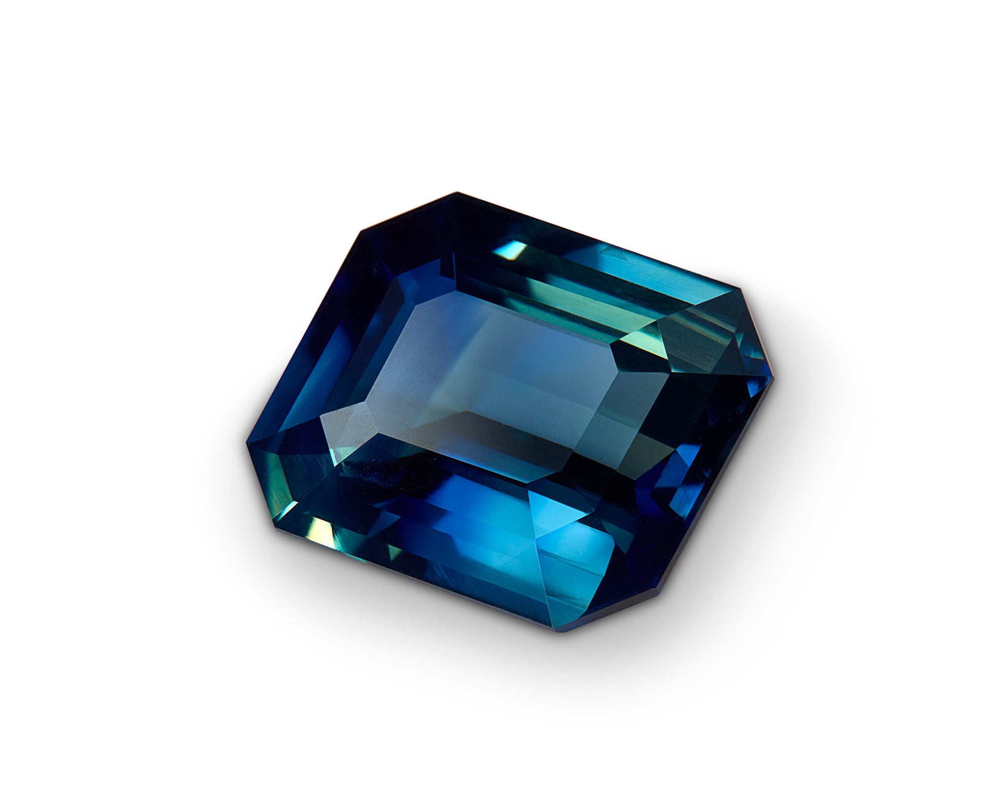 Faceted blue gemstone on a white background