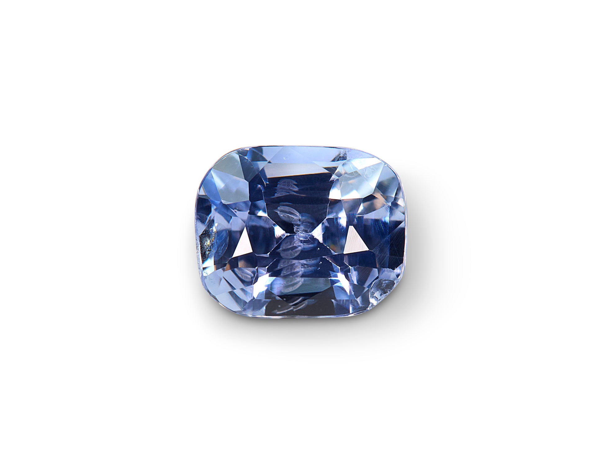 Cushion-shaped blue gemstone on a white background