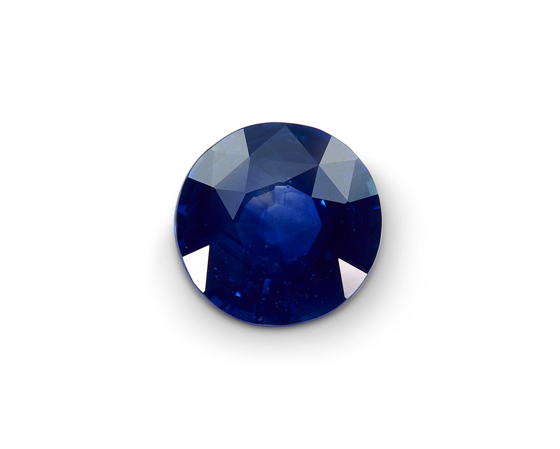 Faceted blue gemstone on a white background
