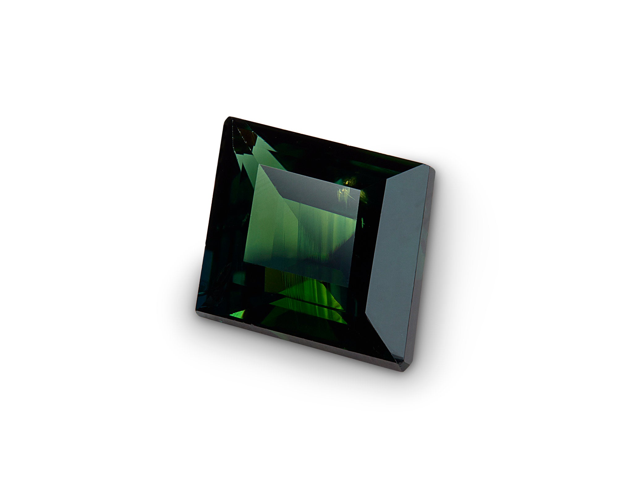 Square-cut sapphire with greenish color on a white background