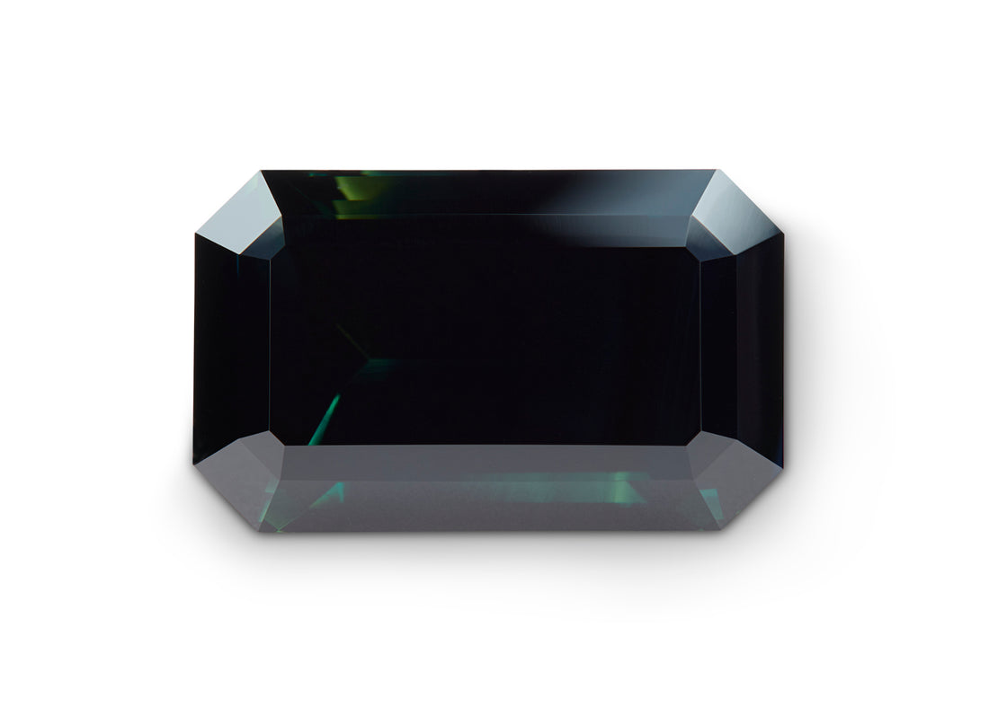 11.68ct Black Sapphire Emerald Cut Australia Origin on white background.