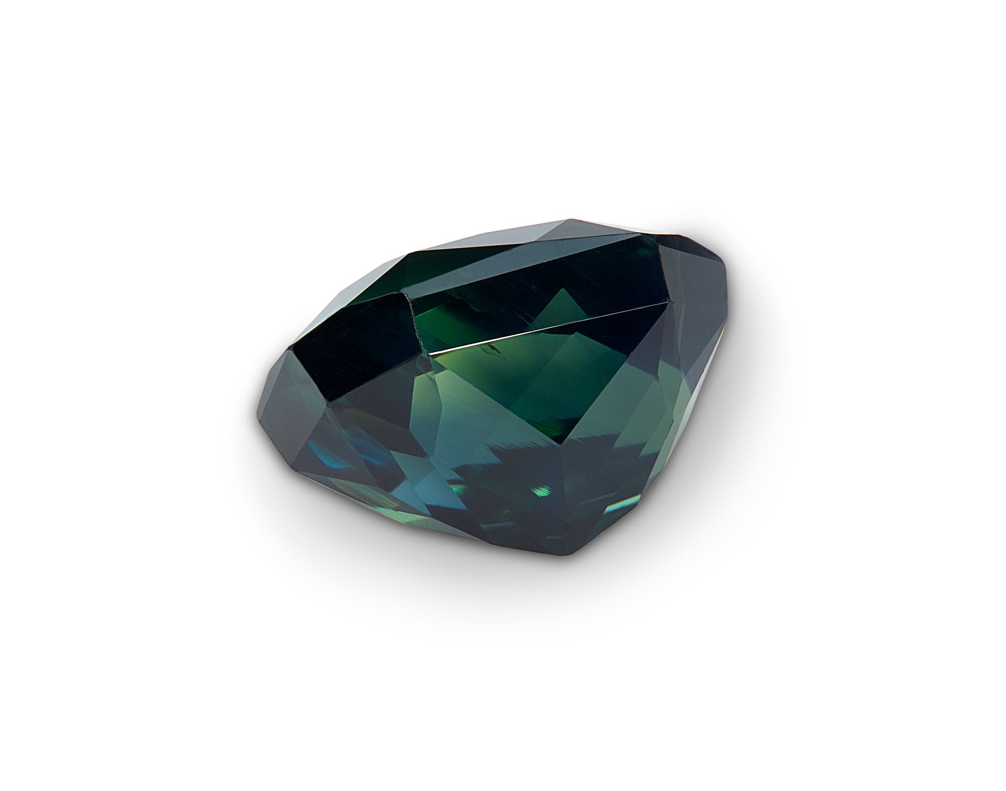 Faceted green gemstone on a white background