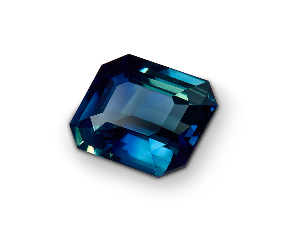 Faceted blue gemstone on a white background