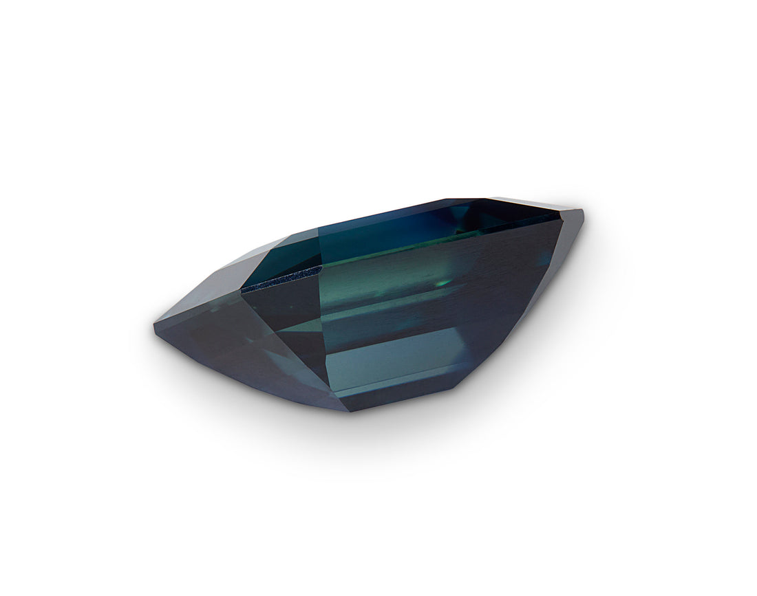 Faceted blue gemstone on a white background