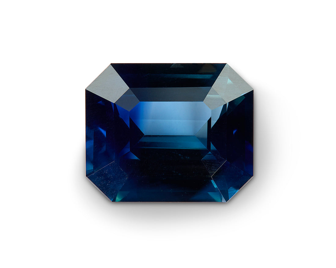 Faceted blue gemstone on a white background